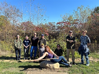 A group of youth with the Society of Ecological Restoration at Ohio State Univversity pose outside.