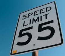 photo of a 55 mph speed limit sign against blue sky