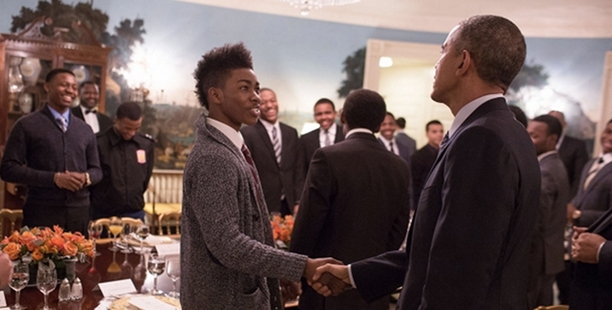 Young man shaking the hand of President Barack Obama