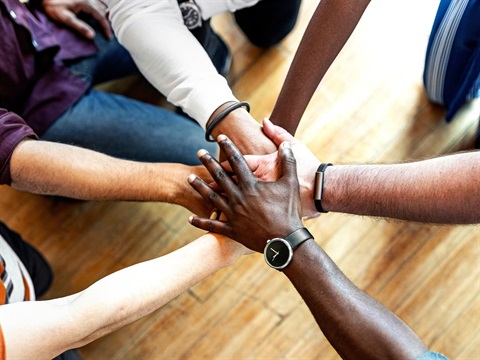 Diverse hands together as seen from above