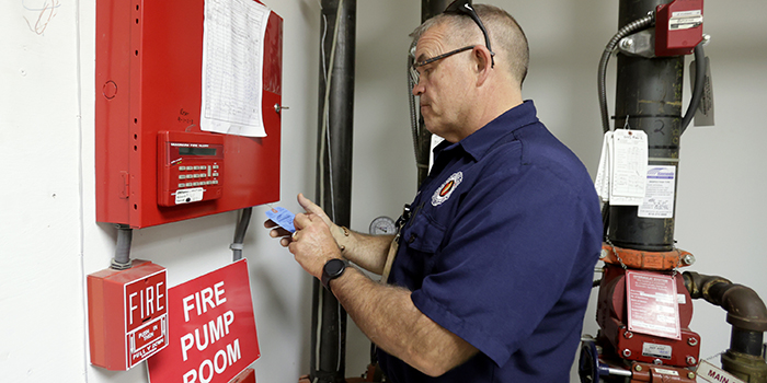 Picture of Inspector reviewing Fire Panel certificates
