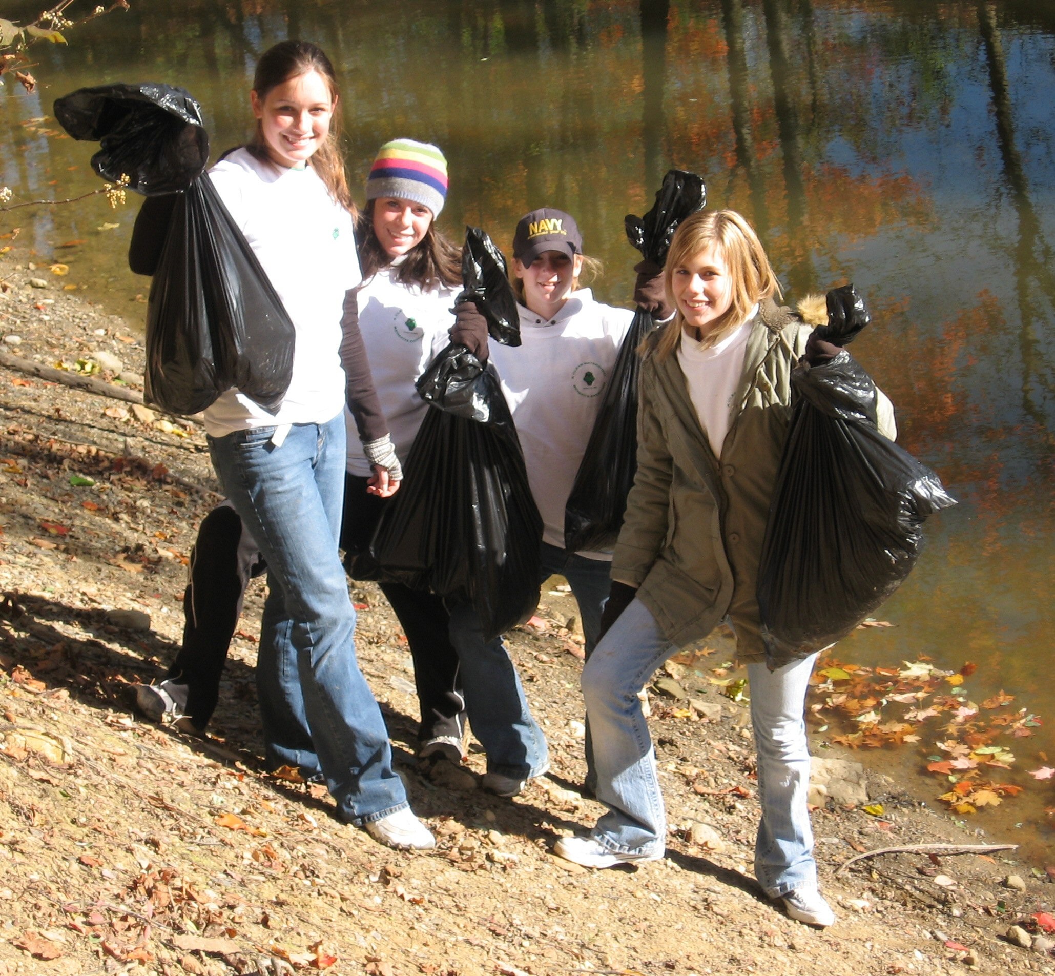 volunteers-near-water-with-trash-bags.jpg